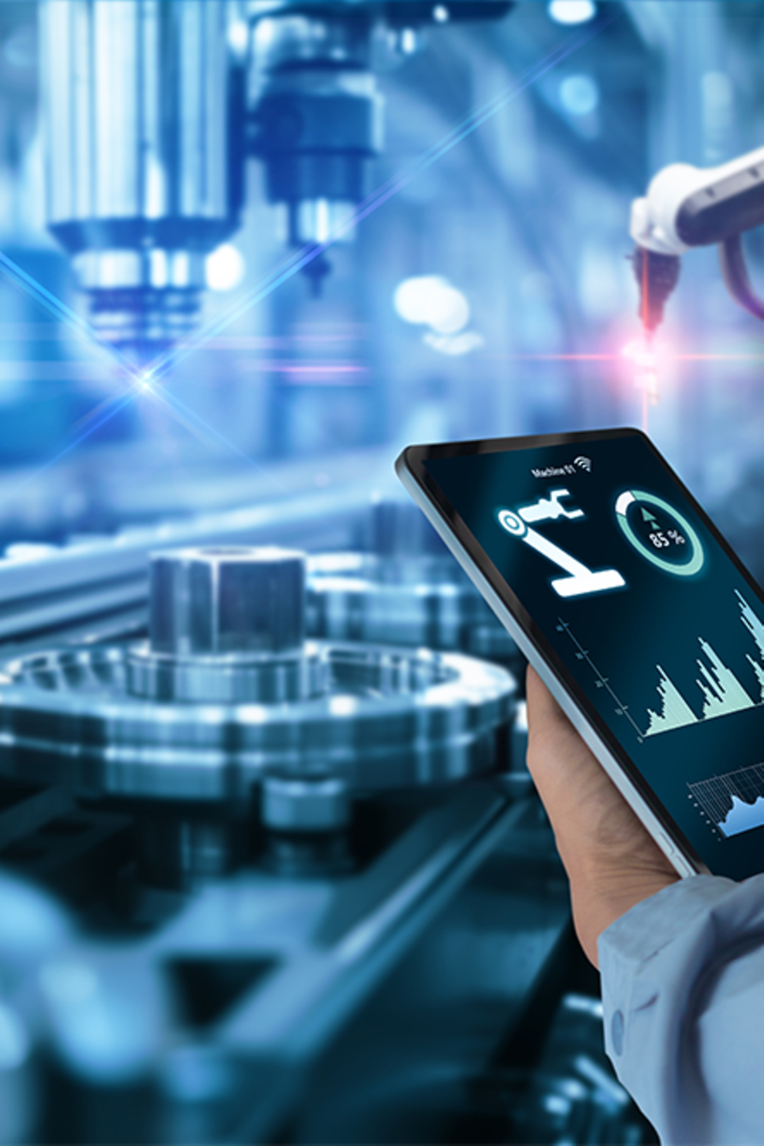 Hands holding tablet on blurred automation machine as background